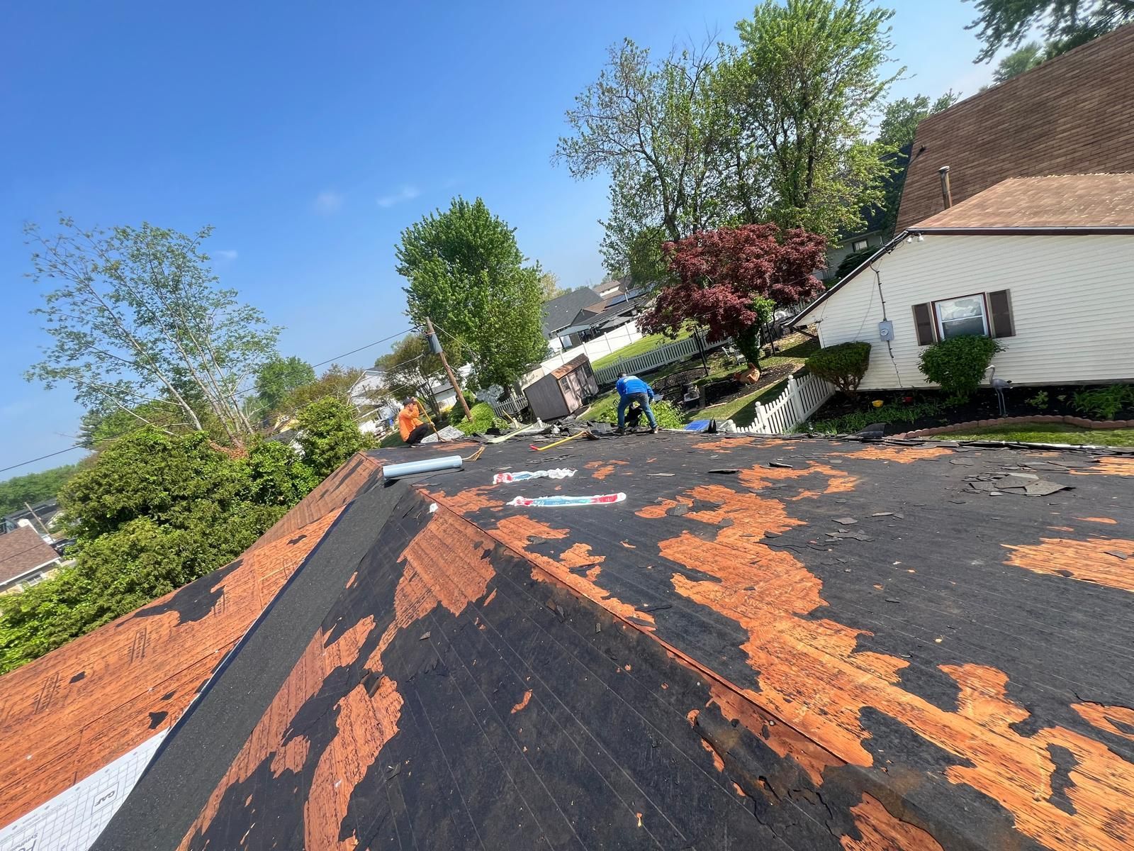 A Roof Is Being Repaired in a Residential Area — Burlington, NJ — AD Roofer Siding & Gutters
