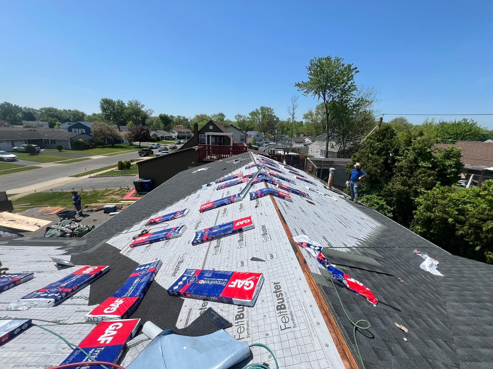 A Roof With a Lot of Shingles Being Installed on It — Burlington, NJ — AD Roofer Siding & Gutters