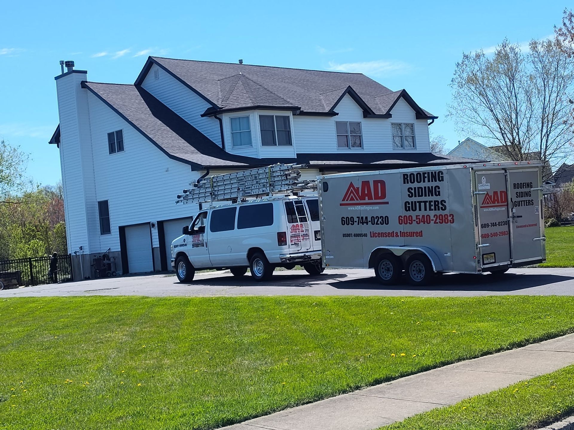 A White Van Is Parked in Front of a Large White House — Burlington, NJ — AD Roofer Siding & Gutters