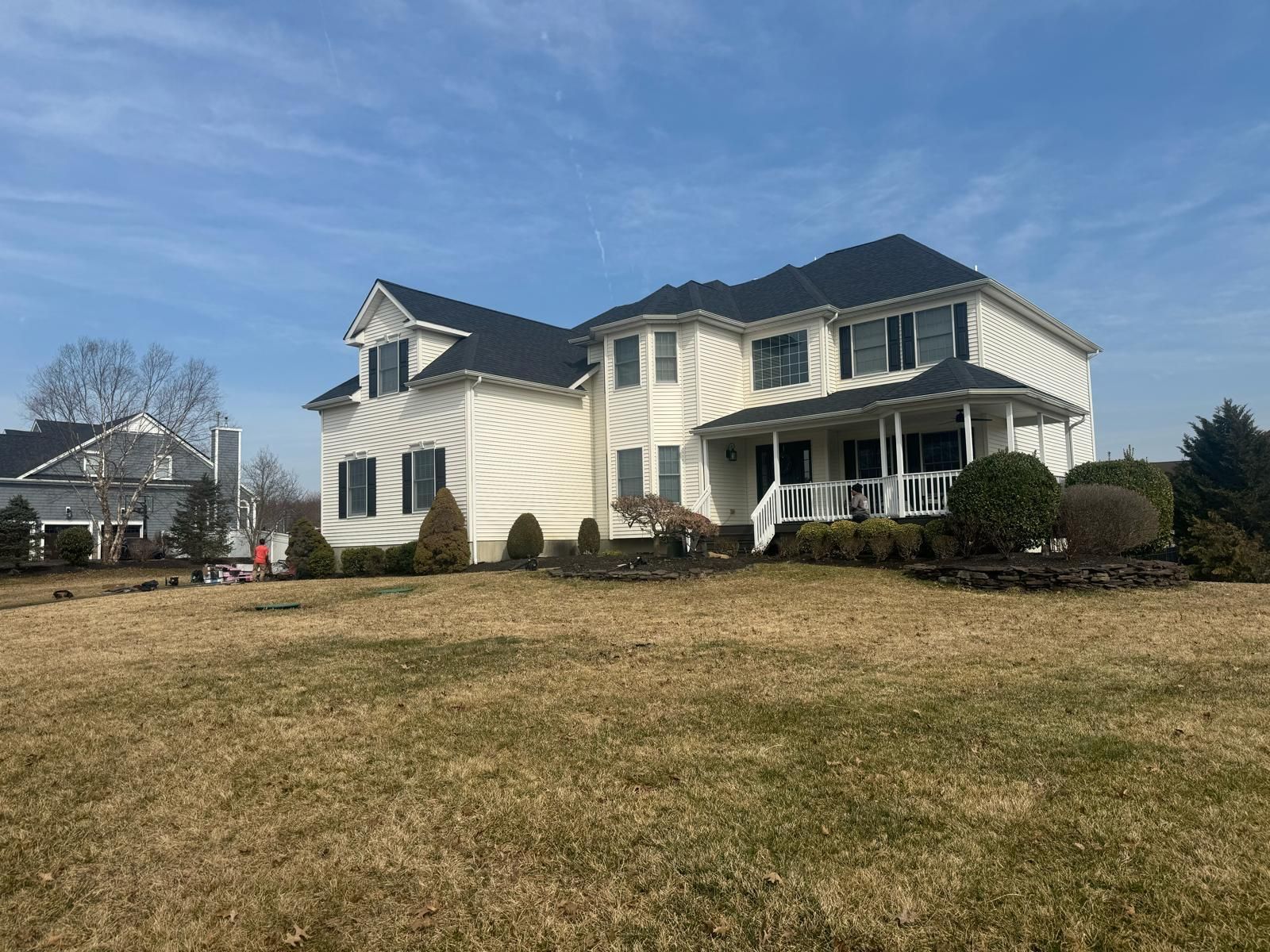 A Large White House With a Black Roof — Burlington, NJ — AD Roofer Siding & Gutters