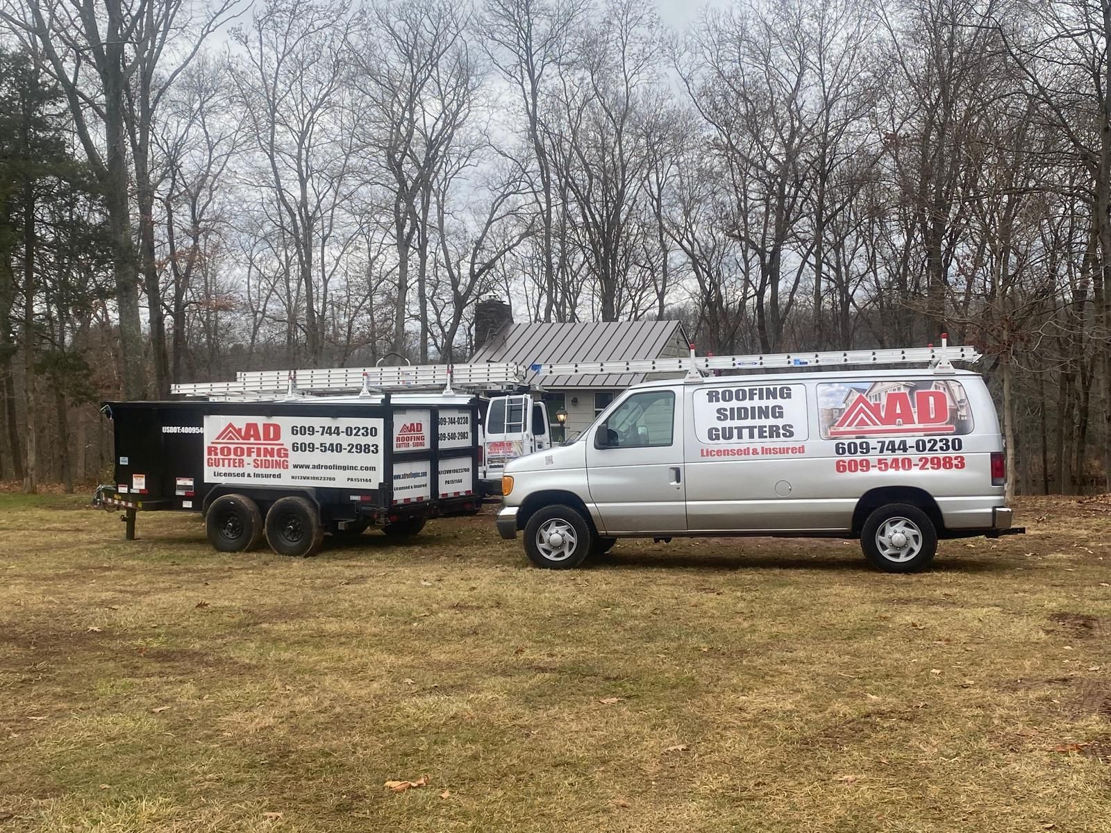 A Van Is Parked in a Field With a House Roof Showing in the Background — Burlington, NJ — AD Roofer Siding & Gutters