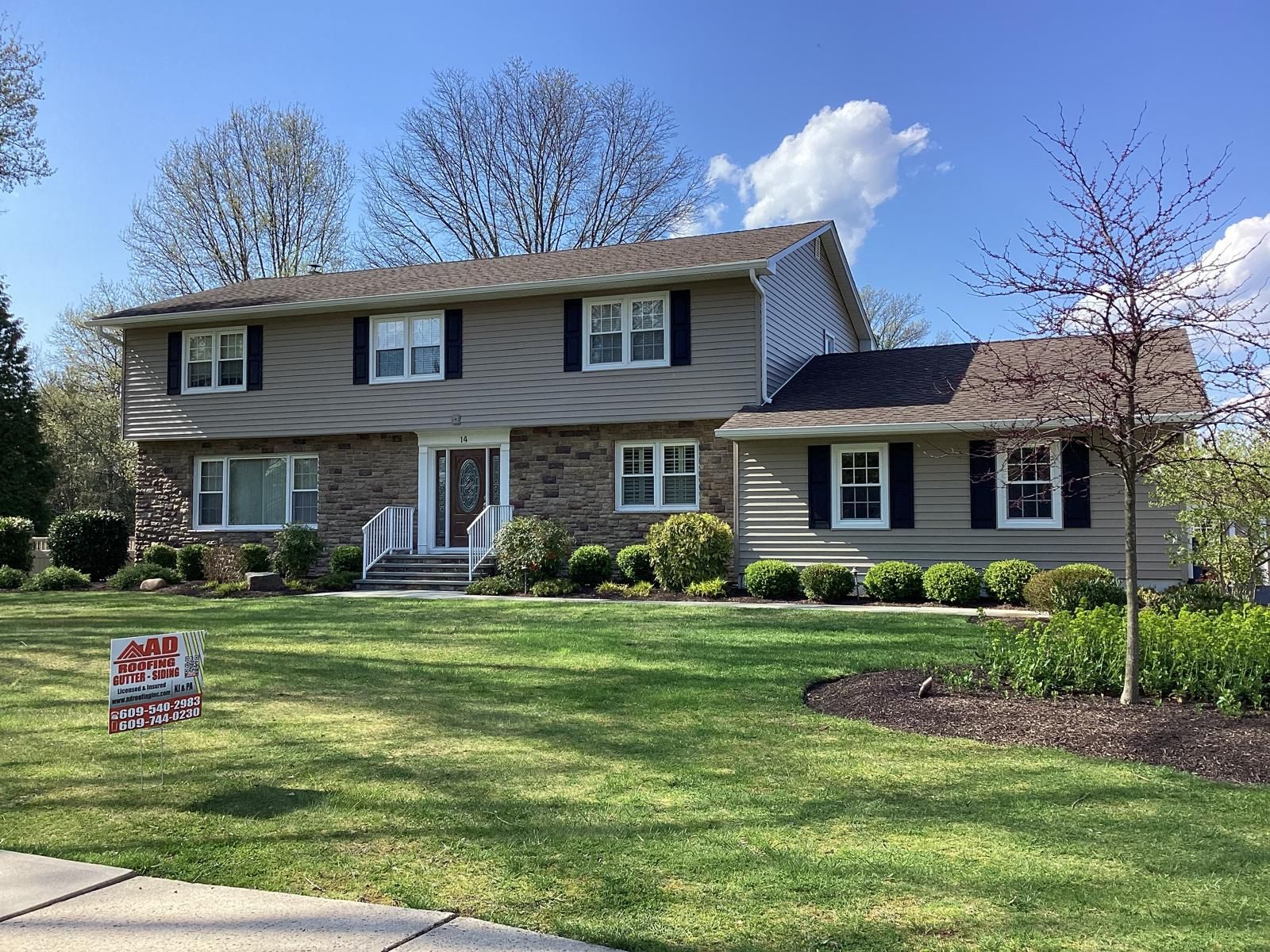 A Large House With a Sign in Front of It That Says for Sale — Burlington, NJ — AD Roofer Siding & Gutters