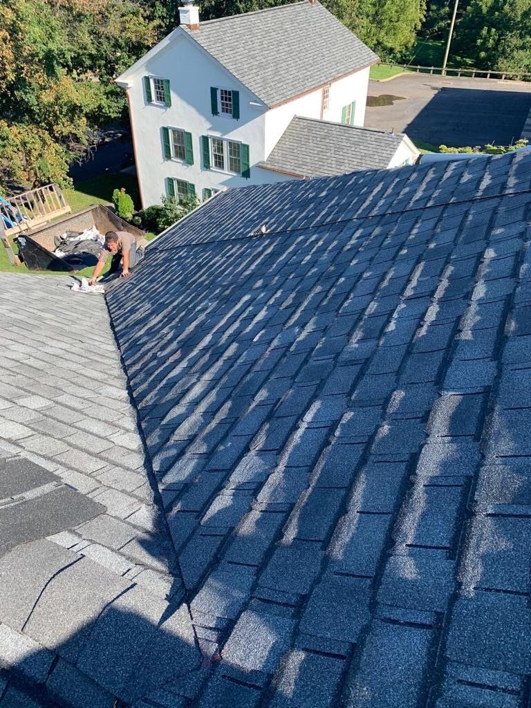 Man Repairs the Roof — Burlington, NJ — AD Roofer Siding & Gutters
