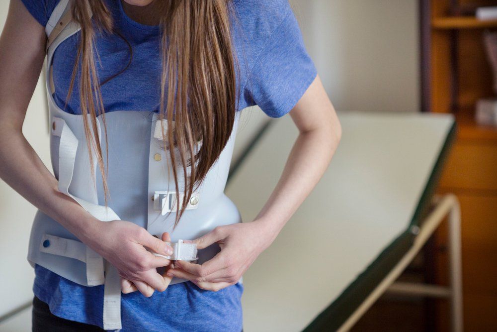 Girl Wearing Back Brace — Tavernier, FL — Garrett Chiropractic & Wellness Center
