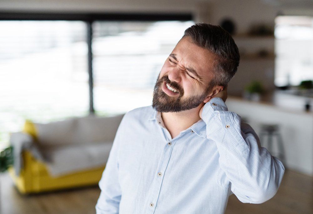 Man With Neckache — Tavernier, FL — Garrett Chiropractic & Wellness Center