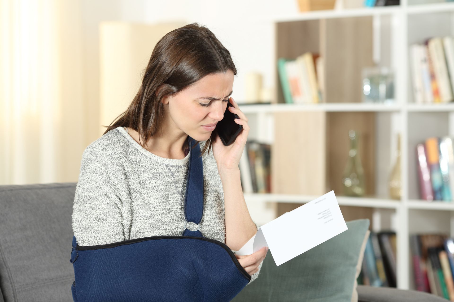 A disabled woman claiming an insurance claim on a mobile phone. A disabled woman claiming an insurance claim on a mobile phone.