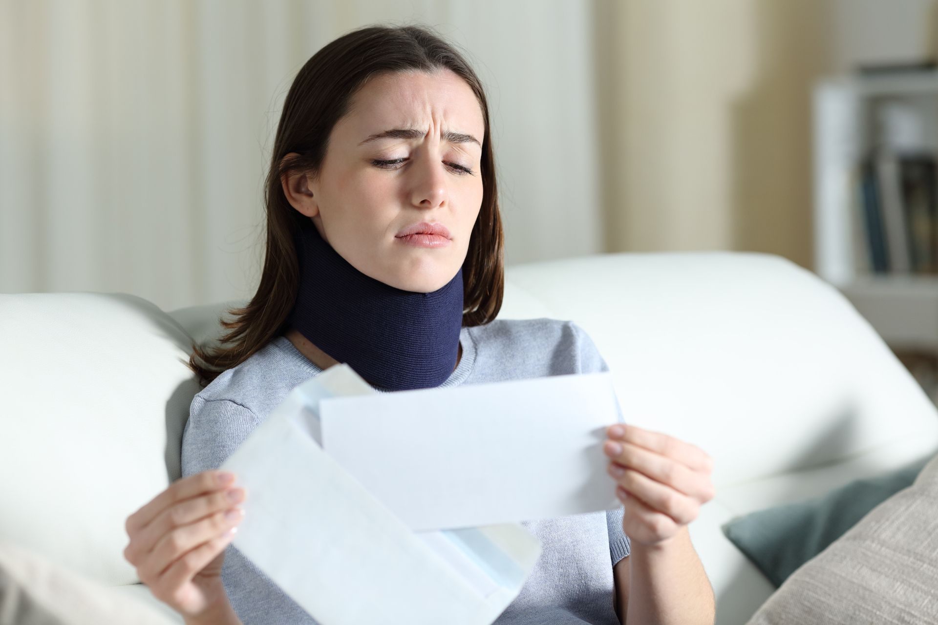 Sad disabled woman reading bad news on a letter about an insurance claim. Sad disabled woman reading bad news on a letter about an insurance claim.