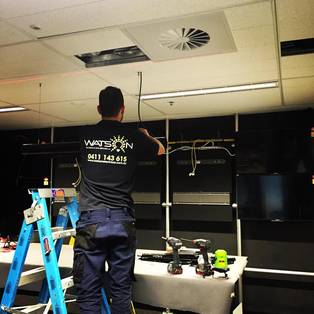 Electrician Working On Commercial Store — Electrical Projects in Balgownie, NSW