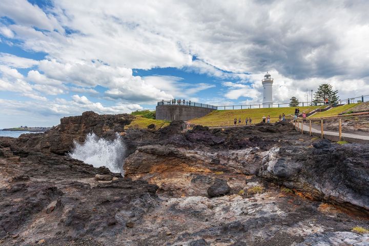 Kiama Lighthouse With Water Spraying Out Of The Blowhole — Locations Services in Sydney, NSW