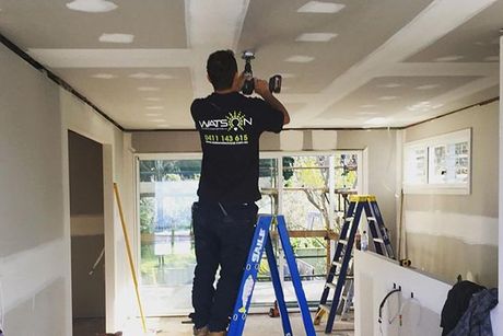Electrician Fixing The Wire On The Living Room — Data Cabling in Balgownie, NSW