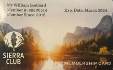 A sierra club membership card with mountains in the background