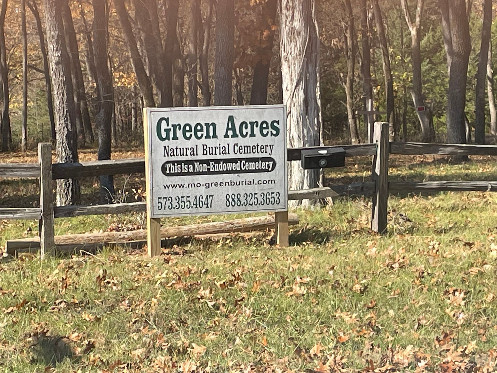 A sign for green acres natural burial cemetery