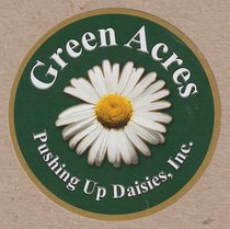 A logo for green acres pushing up daisies inc.