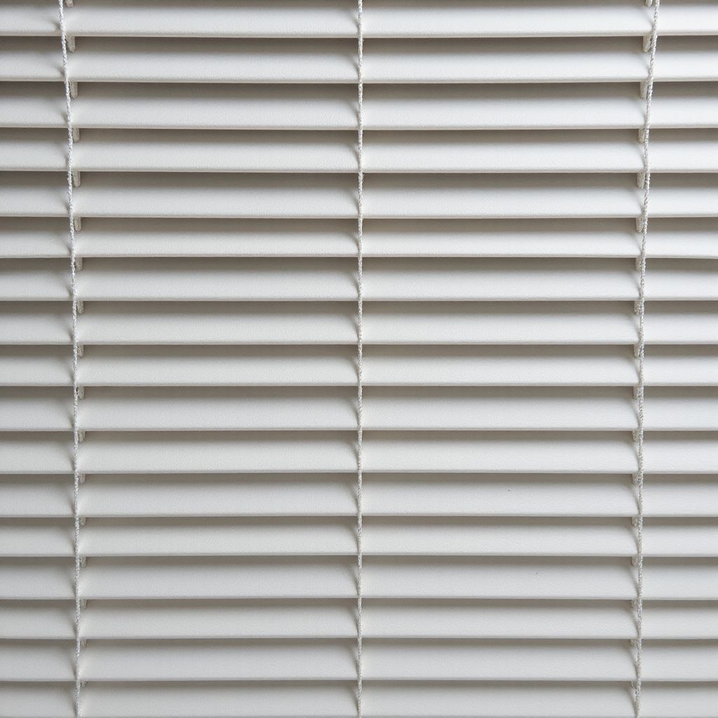 White horizontal blinds, partially closed.