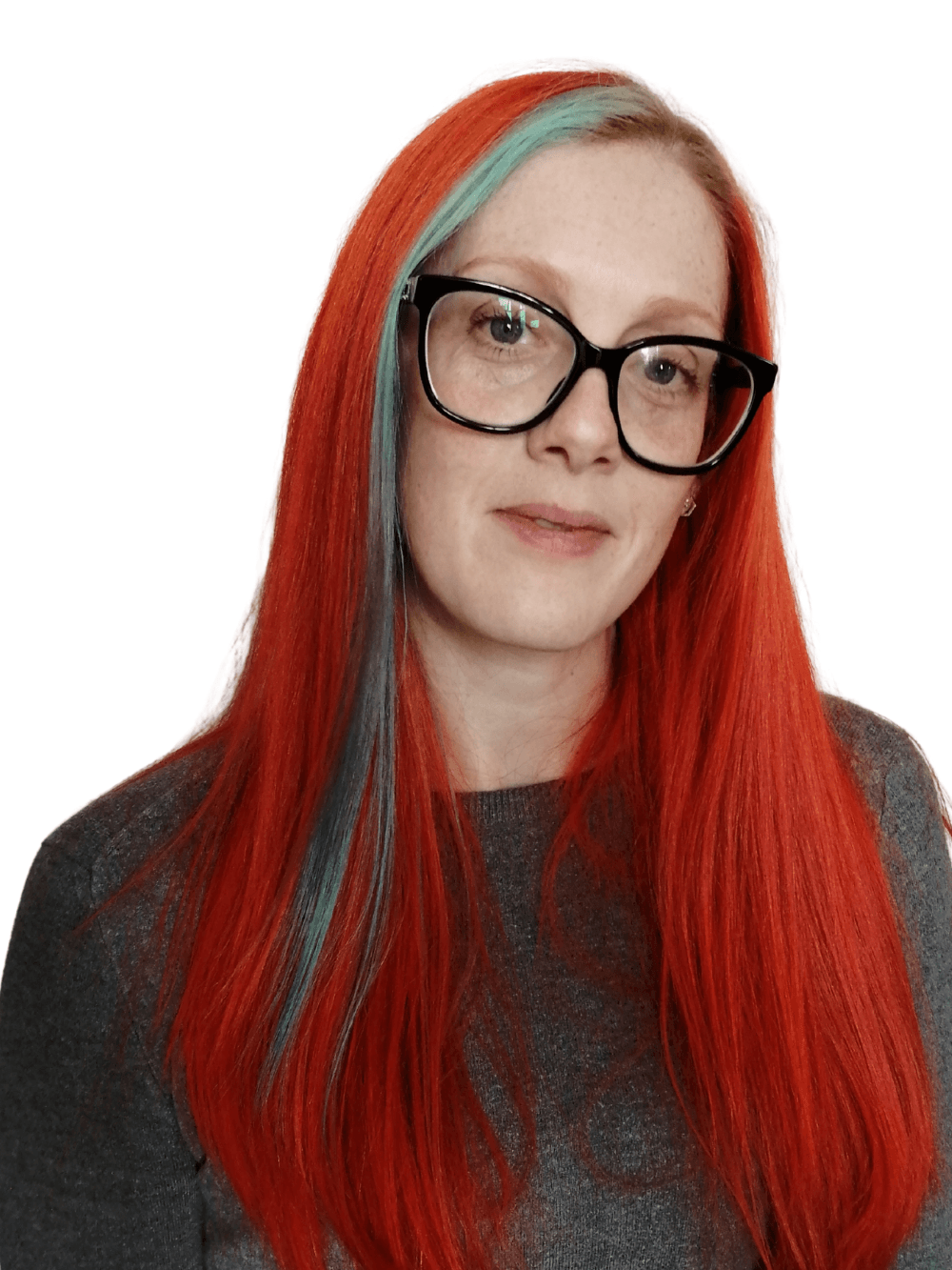 A woman with red hair and glasses is wearing a gray shirt.