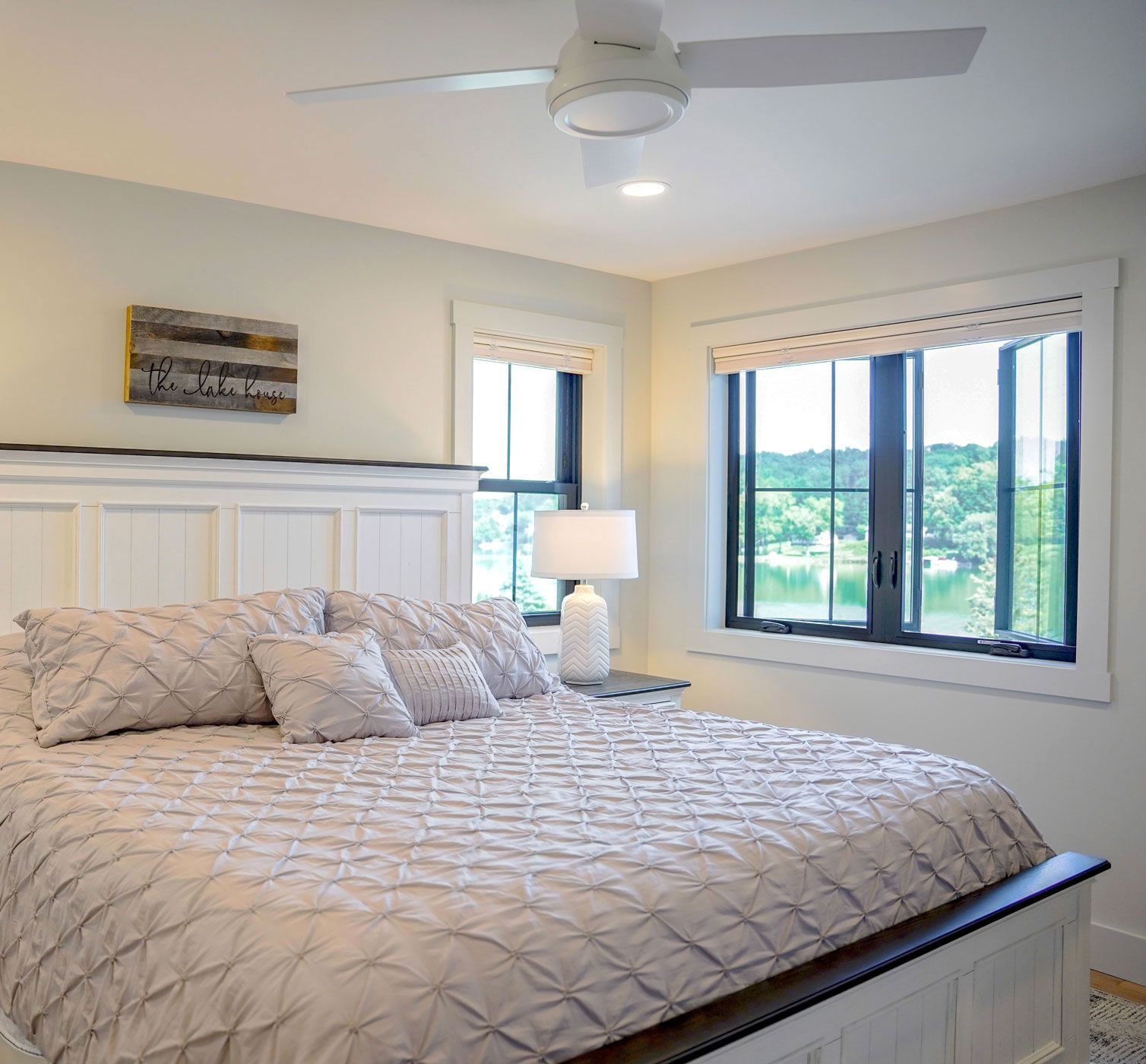 A bedroom with a large bed and a ceiling fan