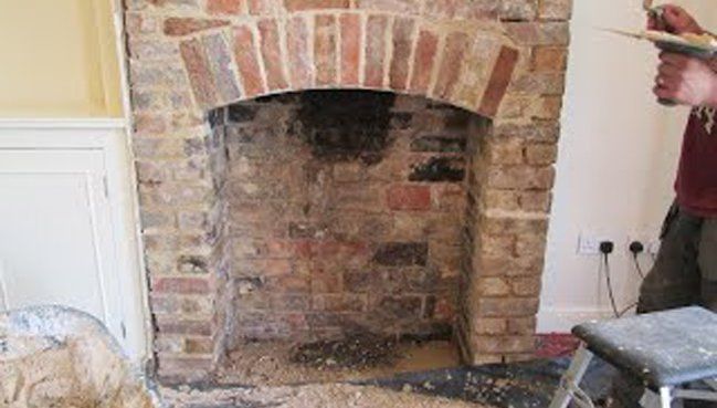 Uncovered fireplace ready for restoration