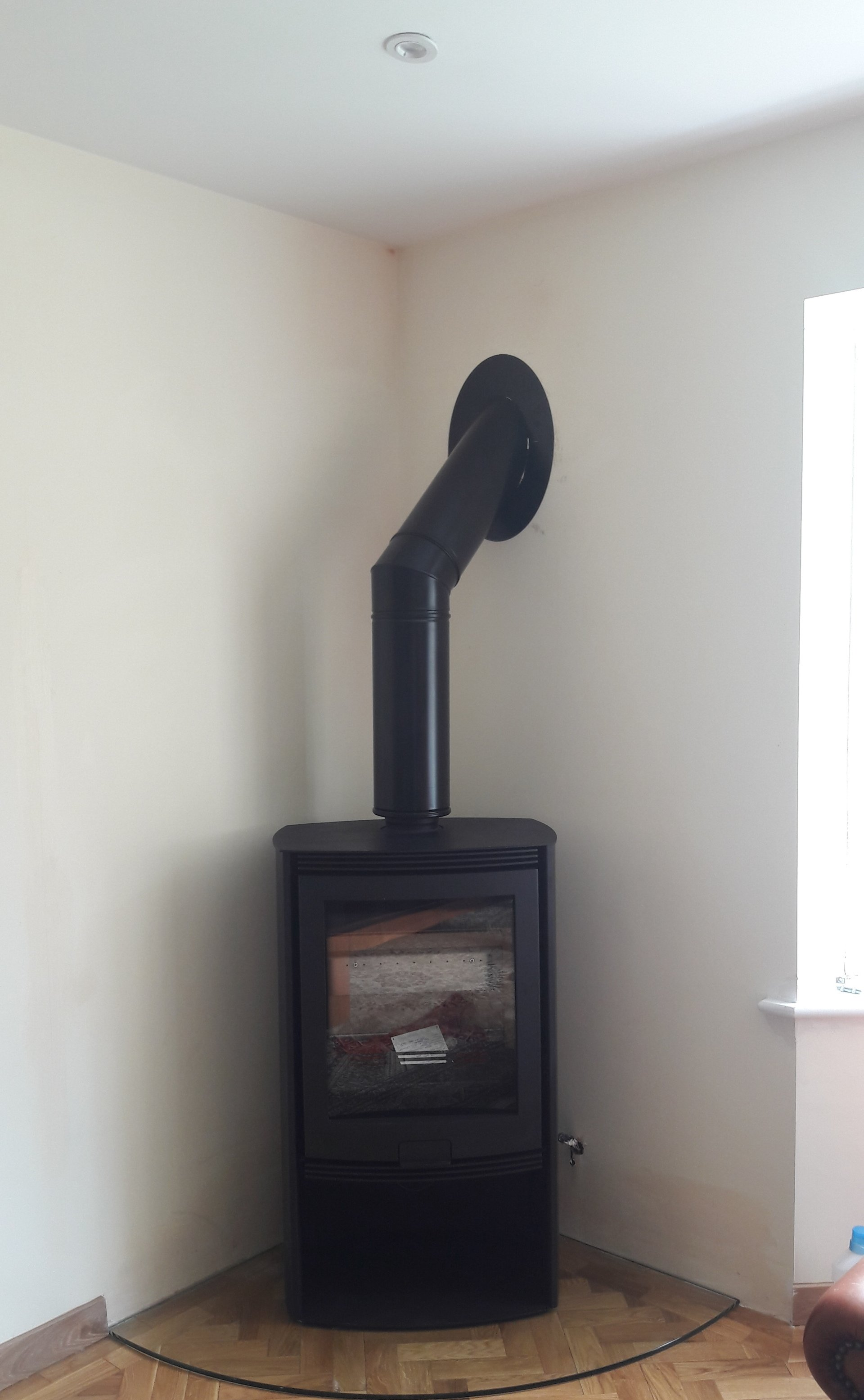 Di Lusso R5 wood burning stove with multi fuel kit on glass hearth