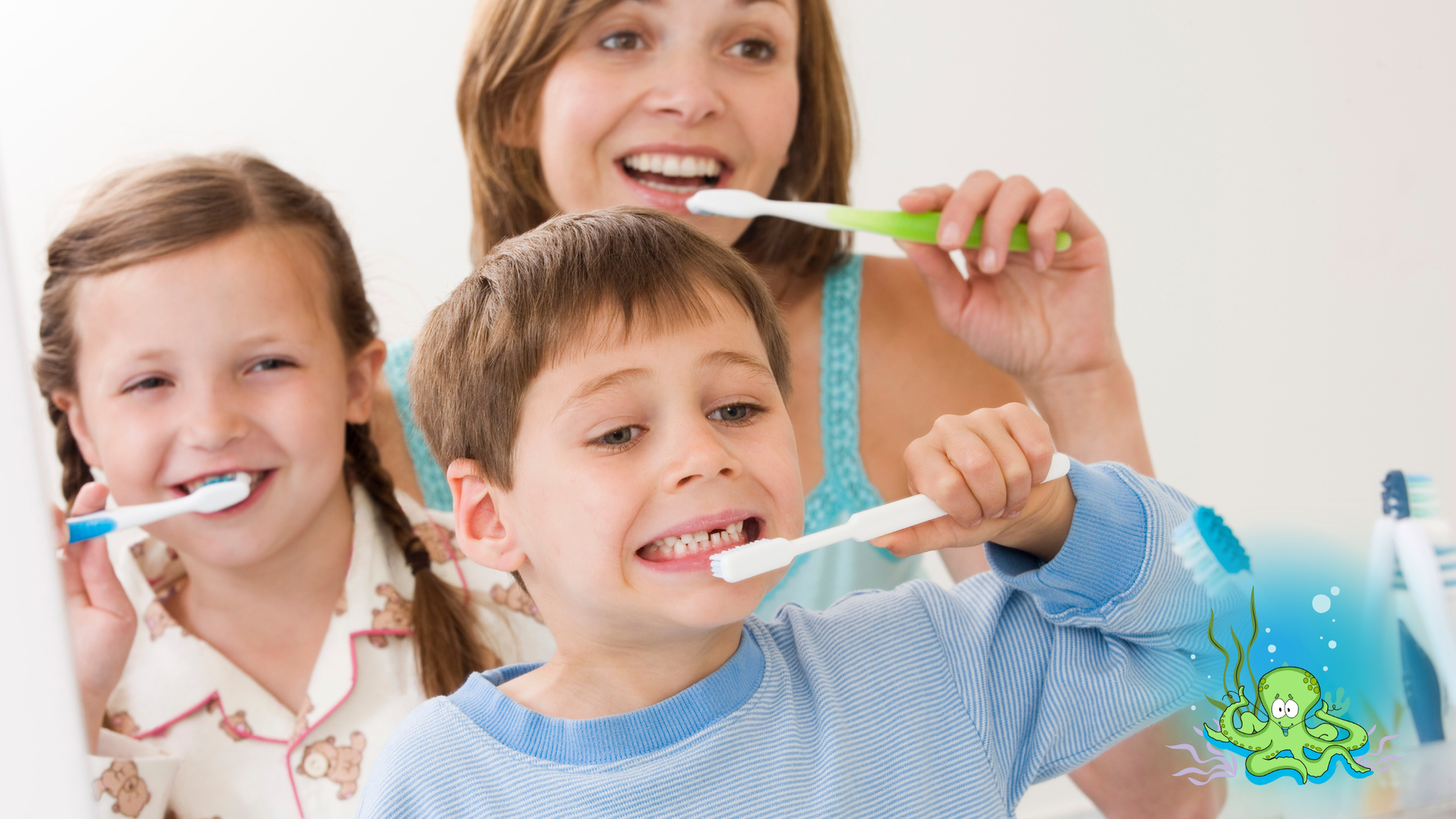 A woman and two children brushing their teeth in front of a mirror.