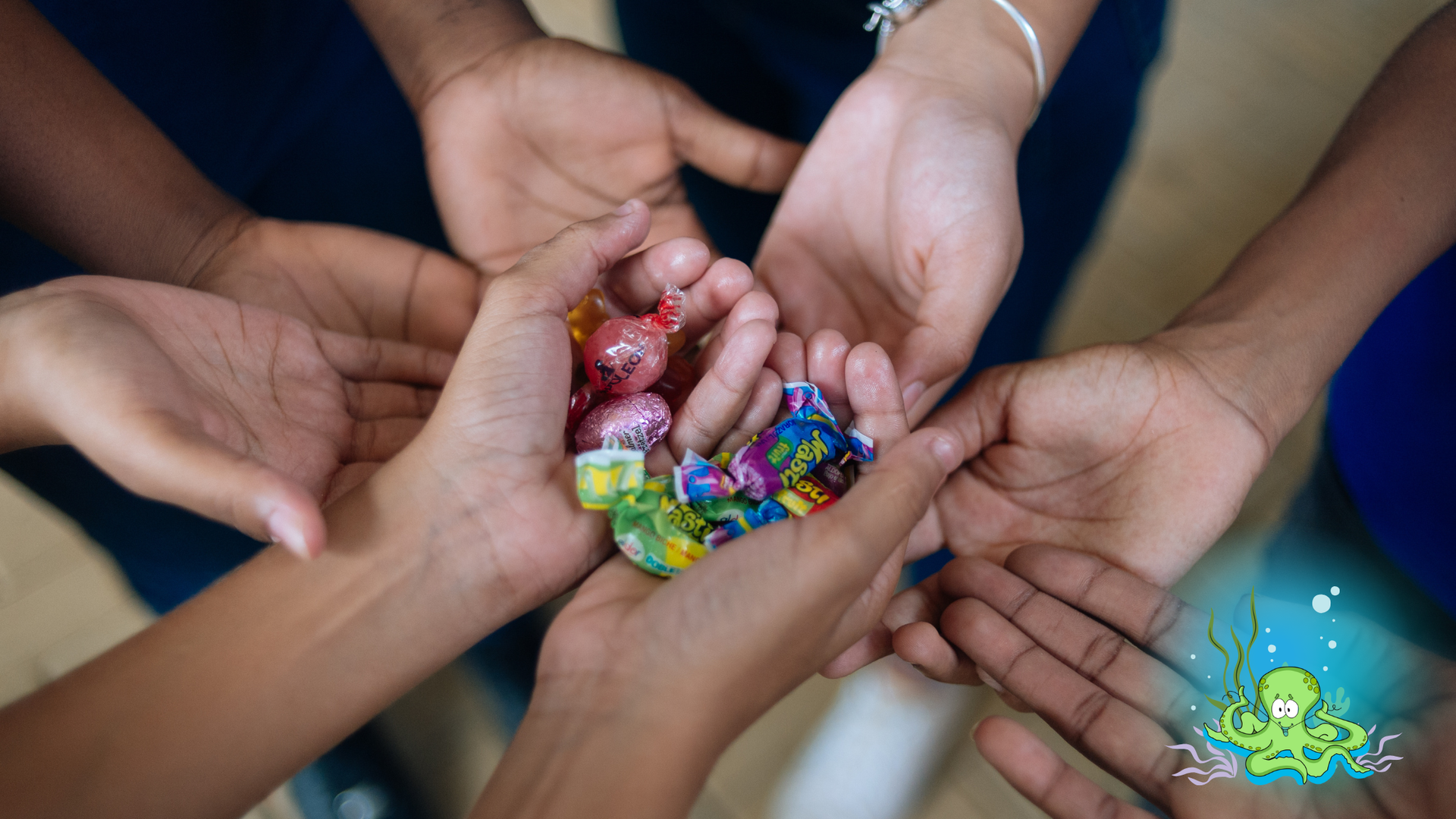 Hands holding colorful marbles, gathered around center.
