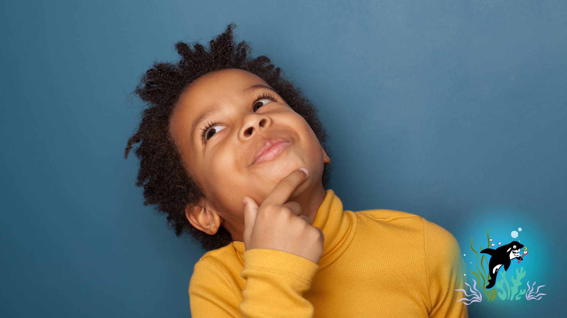 Young child in a yellow turtleneck looks up thoughtfully; cartoon orca in water.