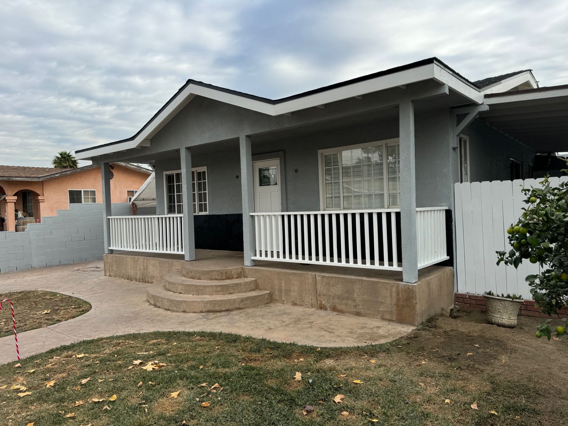 Electrician in yellow hard hat, working on wiring inside a wall.