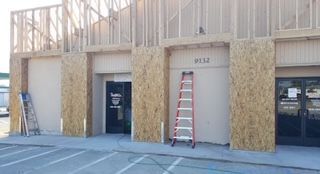 Exterior building construction; OSB sheathing around entryways, ladders, and exposed framing.