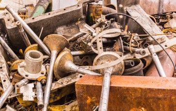 A pile of rusty metal is sitting on top of a table.