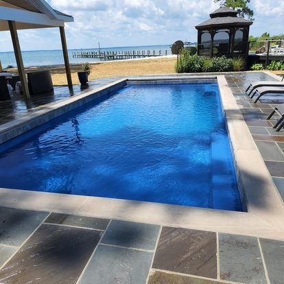 A large swimming pool with a view of the ocean