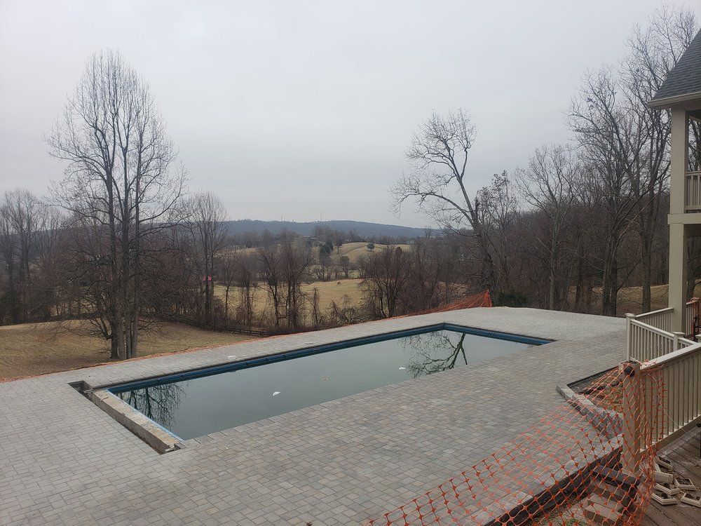 A large swimming pool with a view of a forest