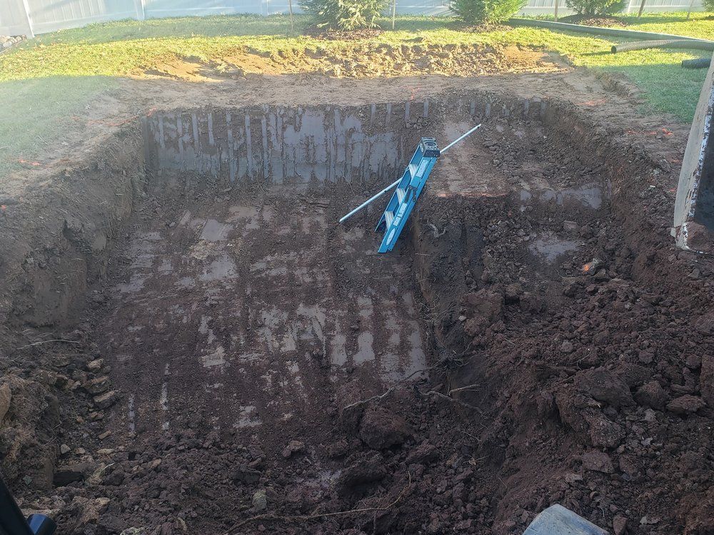A blue kayak is sitting in the middle of a pile of dirt.