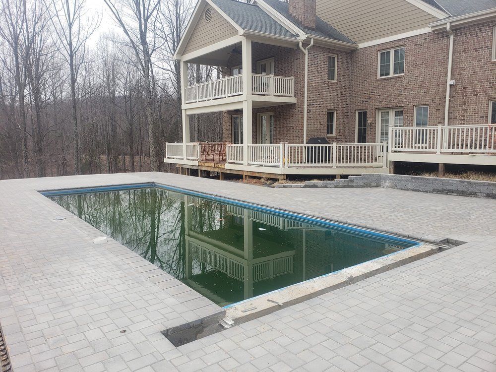 A large house with a large swimming pool in front of it.