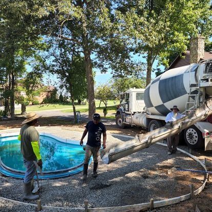 A concrete truck is pouring concrete into a pool.