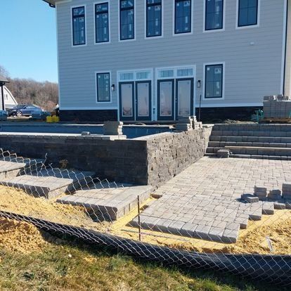 A large white house is being built with a pool in the backyard.