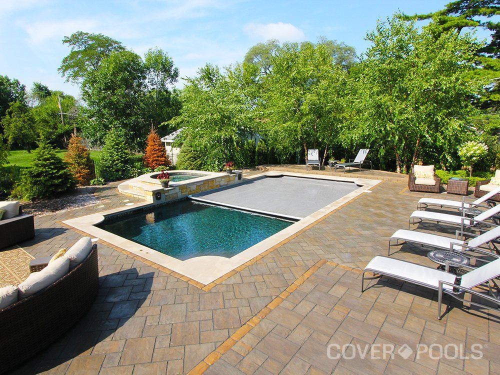 A large swimming pool with a cover on it