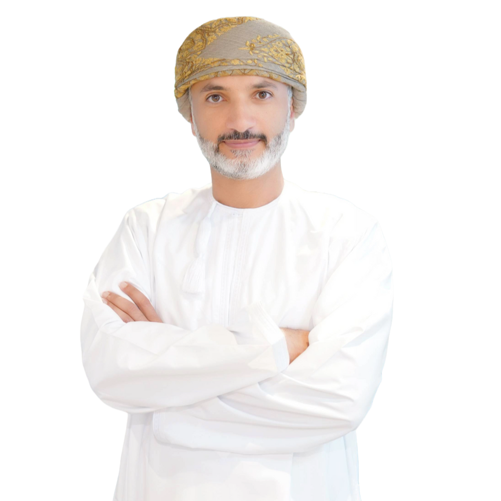 Man in traditional Omani attire; wearing a patterned turban and white dishdasha; neutral expression.