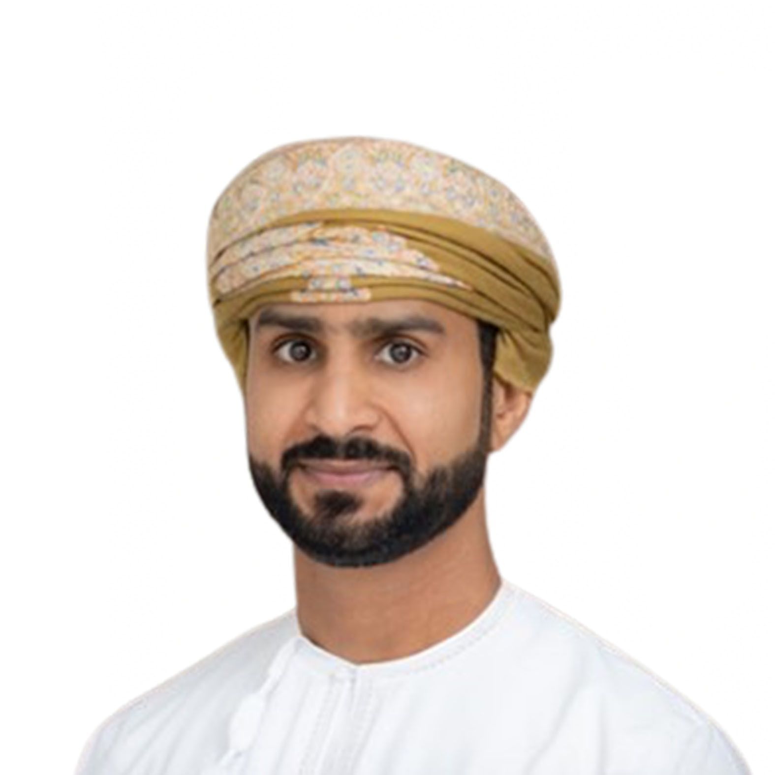 Man wearing traditional Omani headwear, smiling, in white attire.