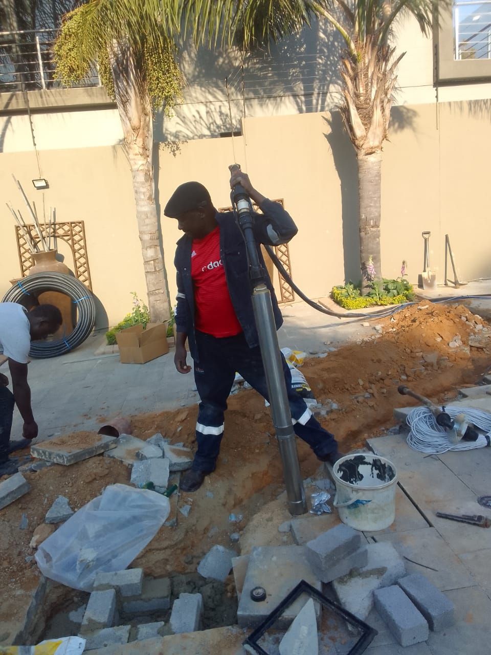 a man in a red shirt is working on a construction site