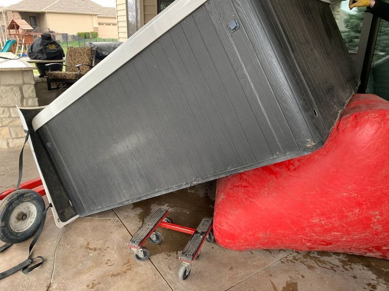 A hot tub is sitting on top of a red chair.