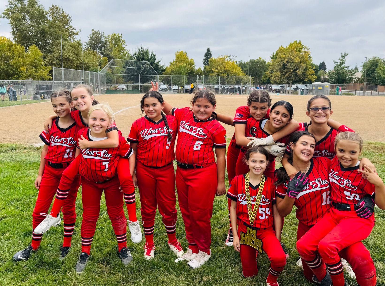 Baseball player sliding into home plate, catcher in front. Blue and gold uniforms, action shot.