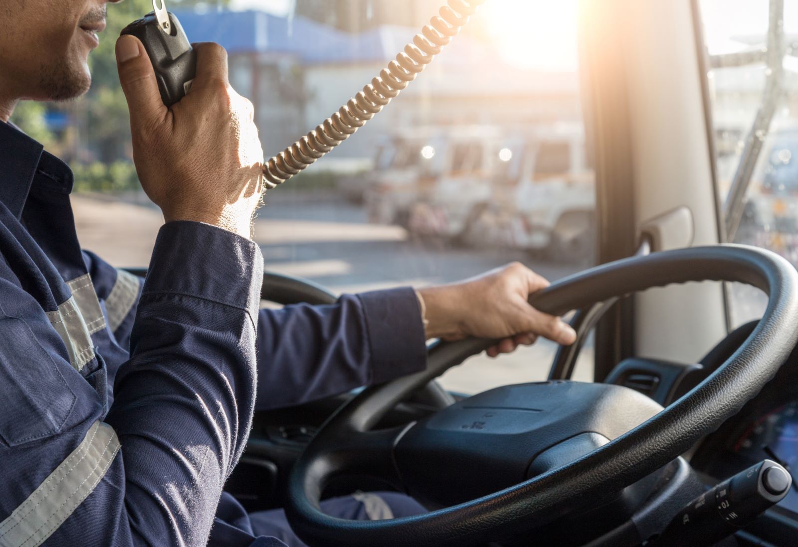 a man is driving a truck and talking on CB Radio