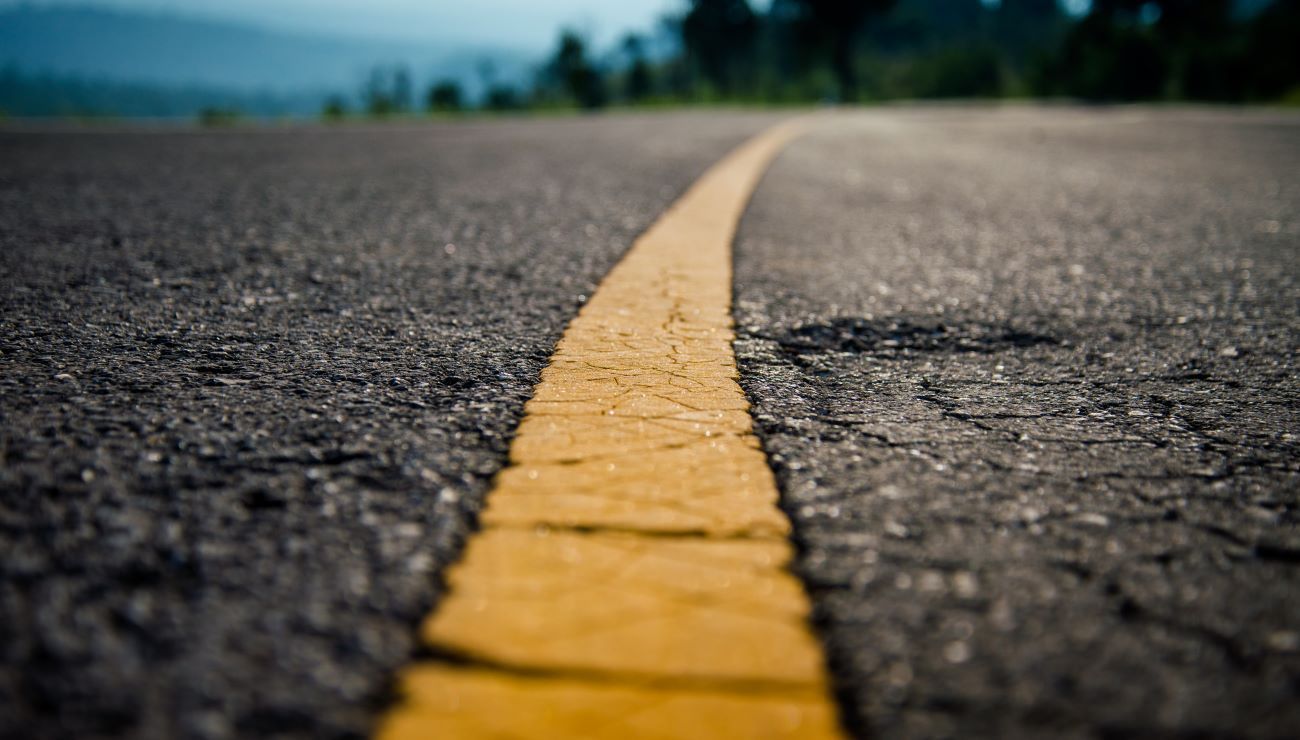 a close up of a yellow line on the side of a road .