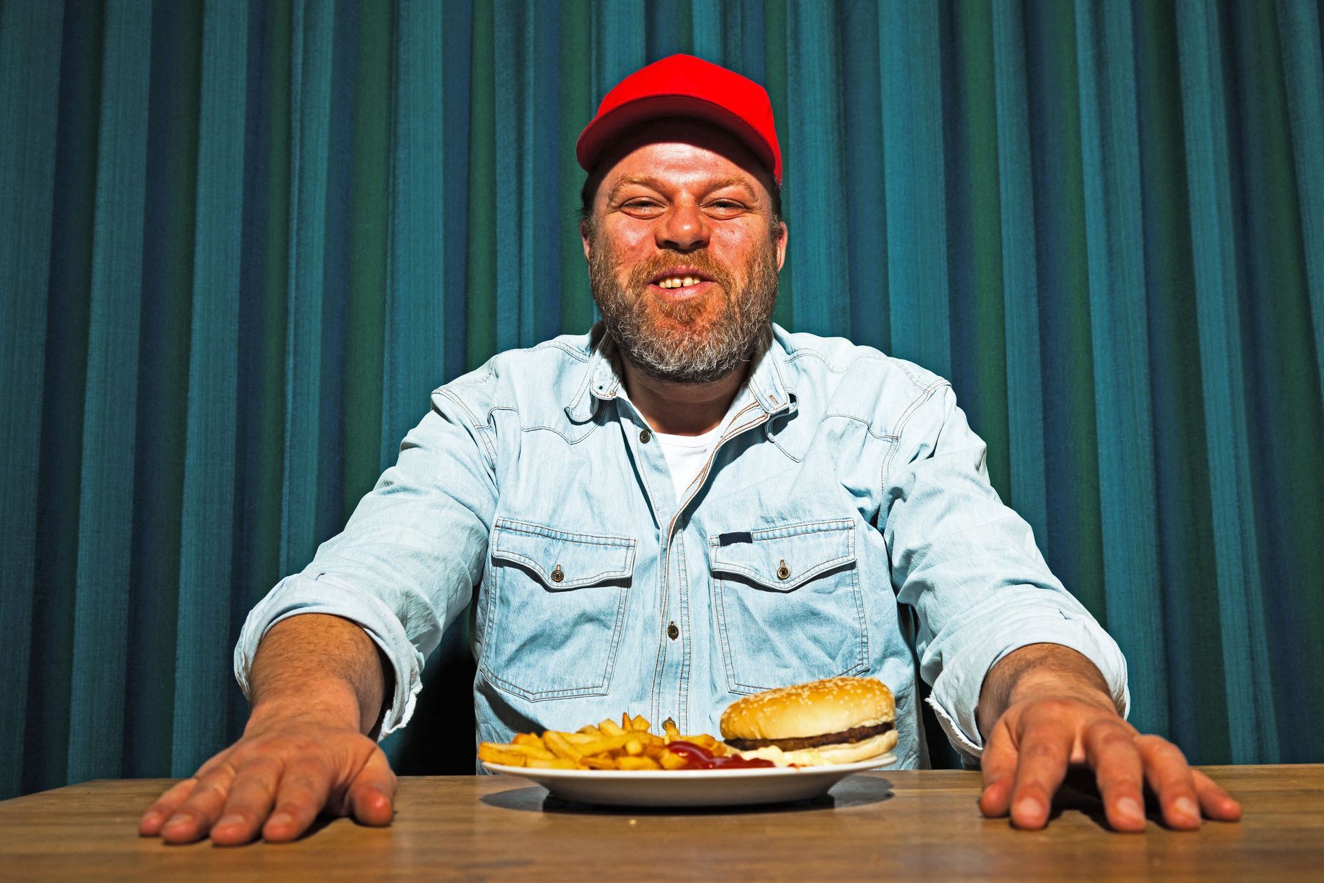 a trucker is sitting at a table with a plate of food 
