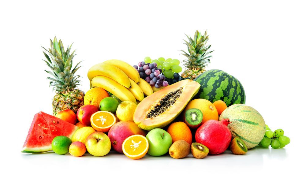 a pile of different types of fruit on a white background .