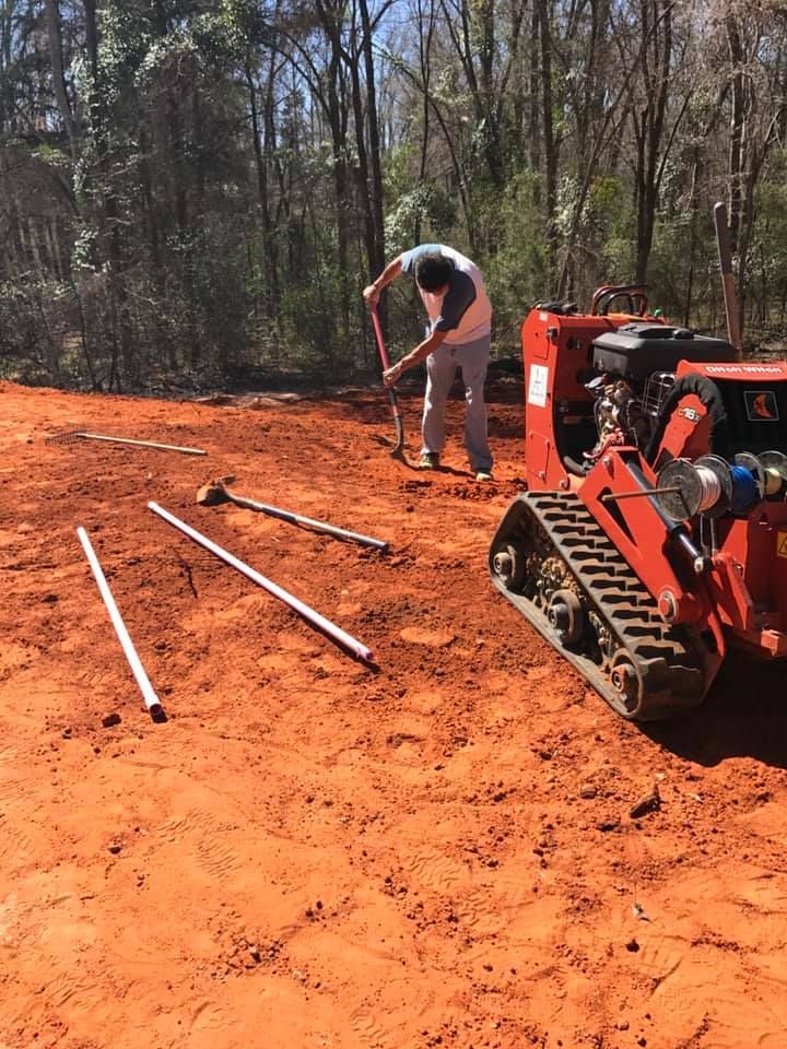 A man is using a shovel to dig a hole in the dirt.
