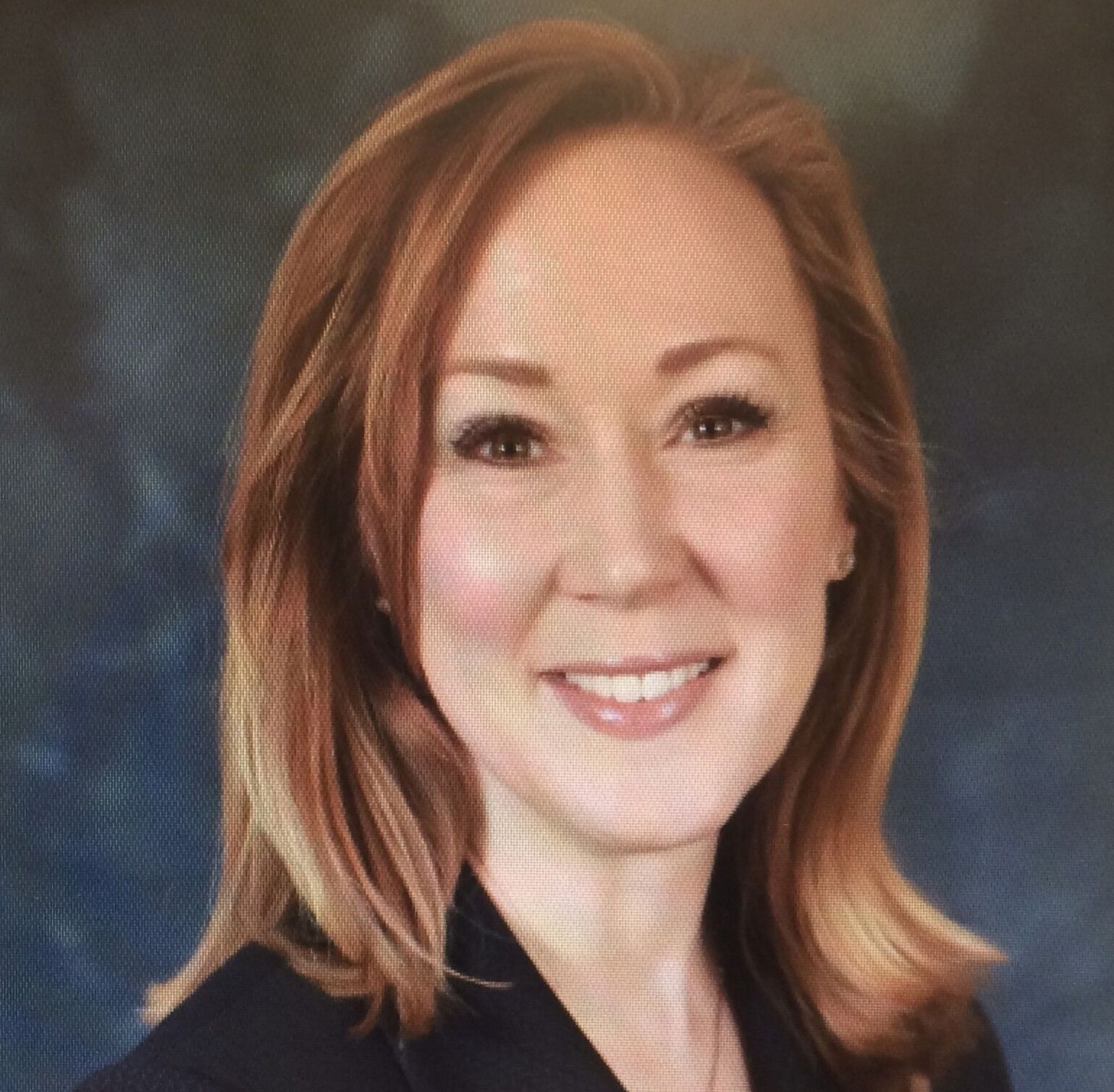A man wearing glasses and a white lab coat with the name john on it