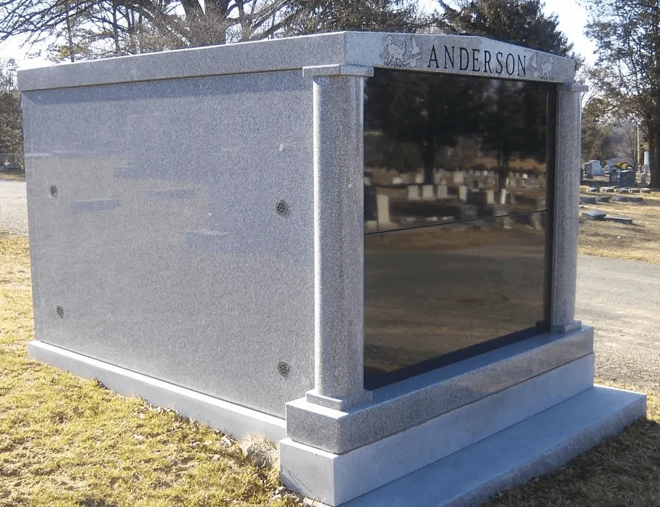 Gray granite mausoleum with the name 