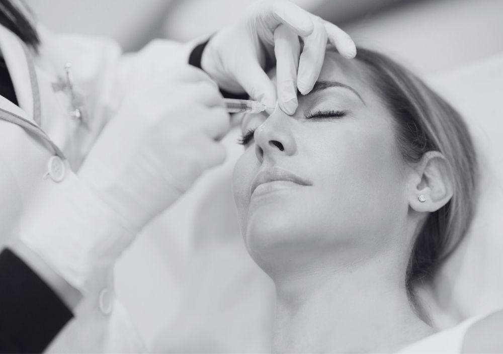 Nose filler being injected near the bridge of the nose