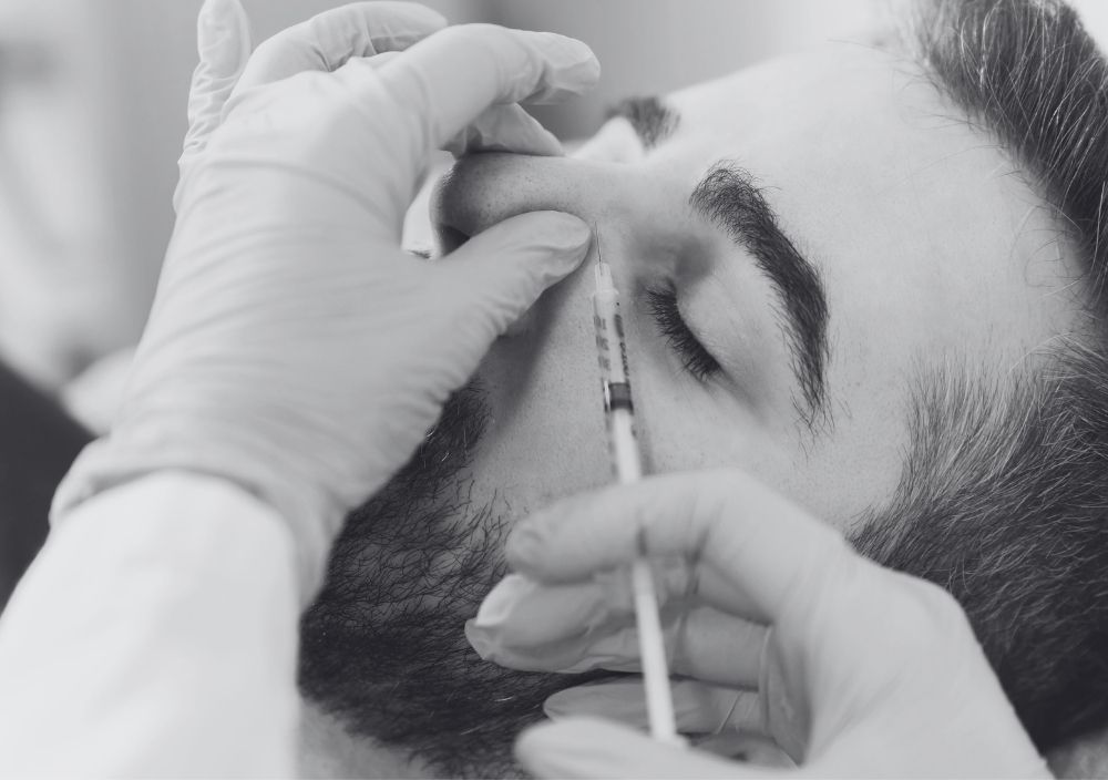 nose filler being injected in to a man's nose