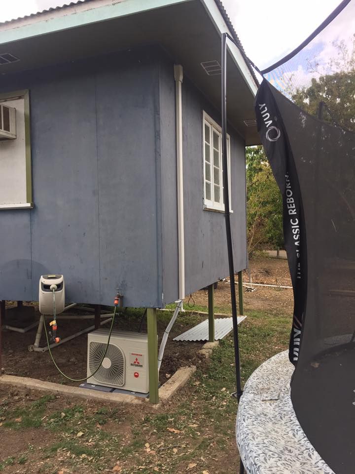 A Trampoline is Sitting in Front of a Blue House — Legit Air Conditioning in Garbutt, QLD